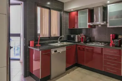 a kitchen with red cabinets and a sink at 