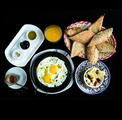a breakfast plate with eggs and toast on a table at 