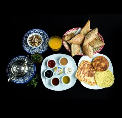 a table with a plate of food with eggs and bread at 