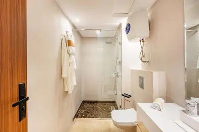 a bathroom with a toilet and a sink and a shower at Modern Jewel Central and Premium comfort in Marrakech