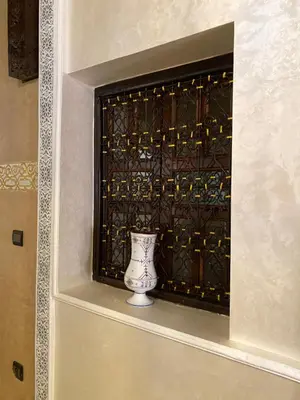 a vase sitting in front of a window at Riad des remparts d'agdal in Oulad Akkou