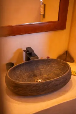 a wooden sink sitting on top of a bathroom counter at Riad Dar Amazonia in Marrakech