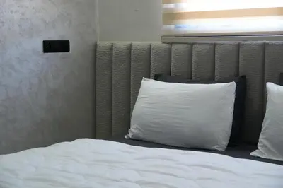 a bed with a white pillow on it at apartment in the center for an excellent stay in Marrakech