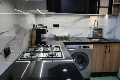 a kitchen with a stove and a washing machine at apartment in the center for an excellent stay in Marrakech