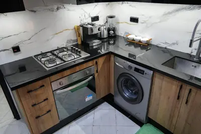 a kitchen with a stove and a washing machine at apartment in the center for an excellent stay in Marrakech