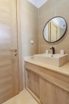 a bathroom with a sink and a mirror at New Charming apartment with swimming pool in Marrakech