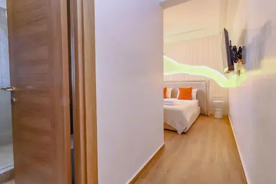 a room with a bedroom with a bed and a door at New Charming apartment with swimming pool in Marrakech