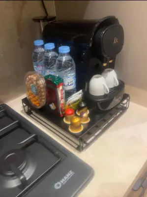 a kitchen counter with a coffee maker and some food at AquaEros - Appart Jacuzzi Carré Eden Marrakech in Marrakech