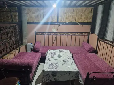 a room with two beds and a table and chairs at studio chez l'habitant in Marrakech