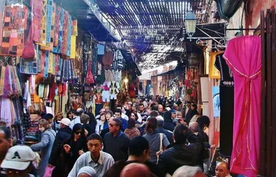 a crowd of people walking through a crowded market at studio chez l'habitant in Marrakech
