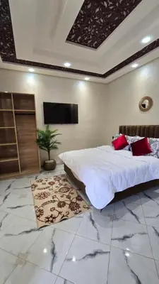a bedroom with a large bed and a flat screen tv at Near Airport hosting in Marrakech