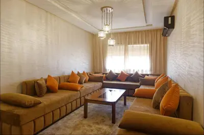 a large living room with couches and a table at Appartement Marrakech 2 Chambres De Luxe Marron in Marrakech