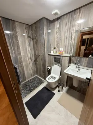 a bathroom with a shower and a toilet and a sink at Appartement Marrakech 2 Chambres De Luxe Marron in Marrakech