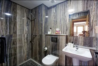 a bathroom with a sink and a toilet and a mirror at Appartement Marrakech 2 Chambres De Luxe Marron in Marrakech