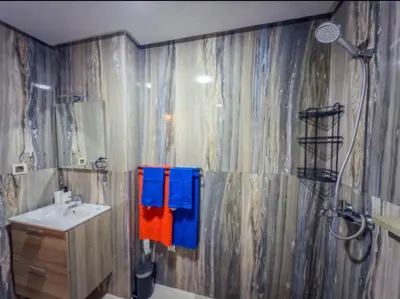 a bathroom with a shower and a sink and a toilet at Appartement Marrakech 2 Chambres De Luxe Orange in Marrakech