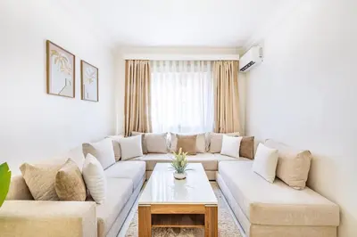 a living room with a couch and a table at Luxueux appartement in Marrakech