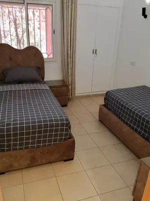 a bedroom with two beds and a window at Appartement Marrakech in Marrakech