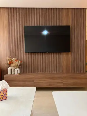 a flat screen tv on a wooden wall at New apartment in Jnane El Guéliz in Marrakech