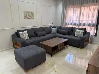 a living room with a couch and a coffee table at Appartement centre ville Marrakech avec Piscine in Marrakech