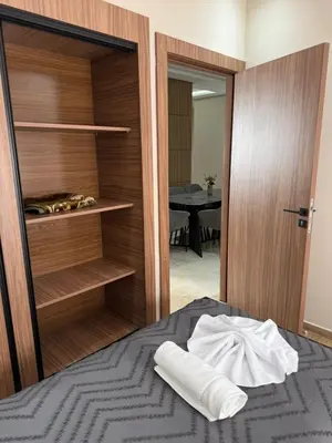 a bedroom with a bed with a open closet at Appartement centre ville Marrakech avec Piscine in Marrakech