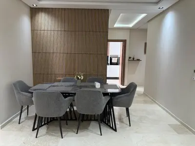 a dining room with a table and chairs at Appartement centre ville Marrakech avec Piscine in Marrakech
