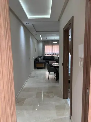 a hallway with a living room and a couch at Appartement centre ville Marrakech avec Piscine in Marrakech