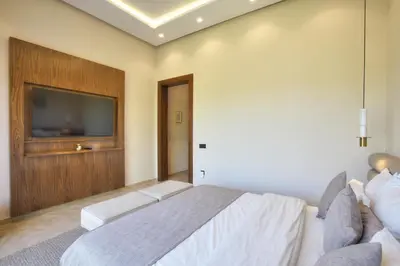 a bedroom with a bed and a flat screen tv at Villa Marrakech in Marrakech