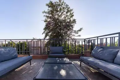 a patio with two couches and a table on a balcony at Villa luxueuse pour un séjour inoubliable in Marrakech