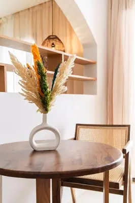 a table with a vase with flowers on it at Architect's studio in the city center! in Marrakech
