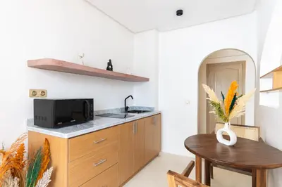 a kitchen with a small table and a microwave at Architect's studio in the city center! in Marrakech