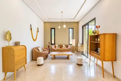 a living room with a couch and a table at Villa Amelkis avec Piscine - 4 suites de luxe à Marrakech in Marrakech