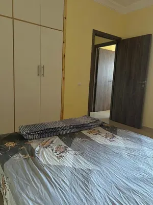 a bedroom with a bed and a large mirror at Apartment 5 minutes from the airport in Marrakech
