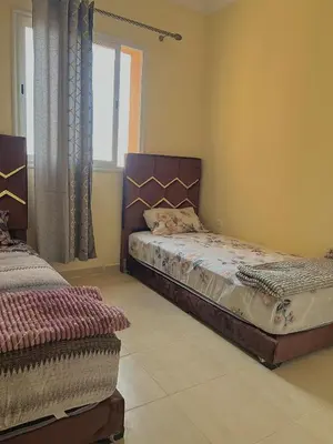 a bedroom with two beds and a window at Apartment 5 minutes from the airport in Marrakech