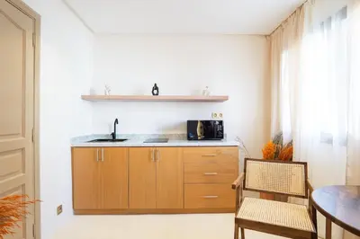 a kitchen with a sink and a microwave at Refined studio in the city center! in Marrakech