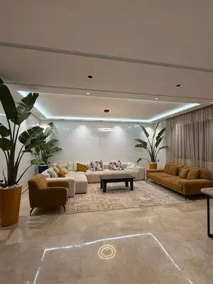 a living room with couches and tables and plants at Villa Aliya in Marrakech
