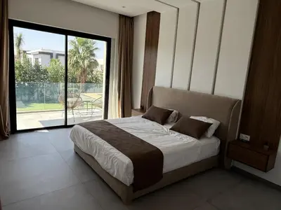 a bedroom with a bed and a large window at Ayline house in Marrakech