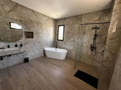 a bathroom with a bath tub and a shower at Ayline house in Marrakech
