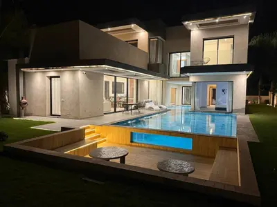 a house with a swimming pool in front of it at Ayline house in Marrakech