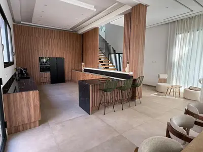 a lobby with a piano and chairs and a staircase at Ayline house in Marrakech