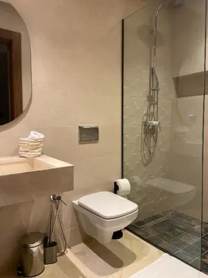 a bathroom with a toilet and a shower at Luxury villa with heated pool and Hamam in Marrakech
