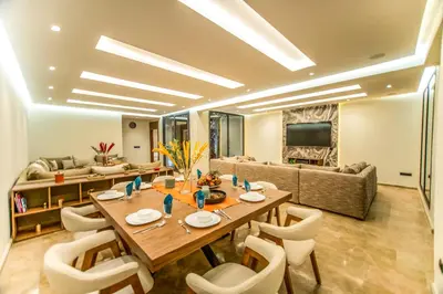 a dining room with a table and chairs and a couch at Luxury villa with heated pool and Hamam in Marrakech