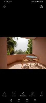 a picture of a table and a bench in a room at pation et jardin in Marrakech