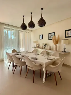 a dining room with a table and chairs and lights at CASA EDEN - Serenity and elegance between Atlas mountains and city center in Marrakech
