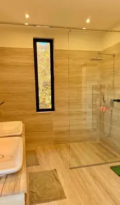 a bathroom with a glass shower and a sink at CASA EDEN - Serenity and elegance between Atlas mountains and city center in Marrakech