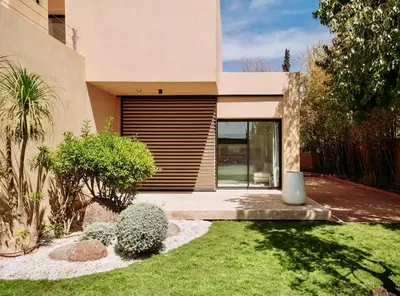 a house with a garden in front of it at CASA EDEN - Serenity and elegance between Atlas mountains and city center in Marrakech