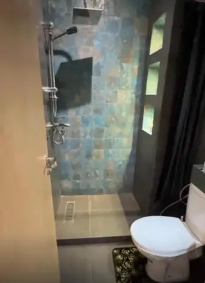 a bathroom with a toilet and a glass shower at إقامة المنتزه الجديد حدا مرجان طريق كازا في مراكش in Marrakech