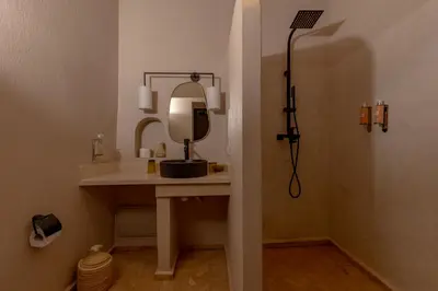 a bathroom with a sink and a mirror at Riad Cedrat in Marrakech