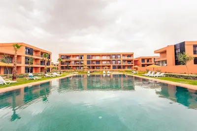 a large swimming pool in front of a building at Prestigia GOLF with Pool Bohemian Cocoon Stylish in Marrakech