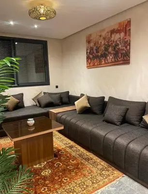 a living room with two couches and a coffee table at Apprt de haut-de-gamme a Jnane awrad in Marrakech