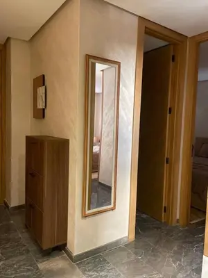 a room with a mirror and a wooden dresser at Apprt de haut-de-gamme a Jnane awrad in Marrakech